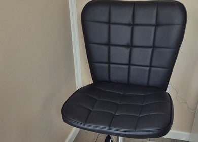 Elegant black chair at Fingers and Toes, Mexborough, England, GB, offering comfort in a serene setting.