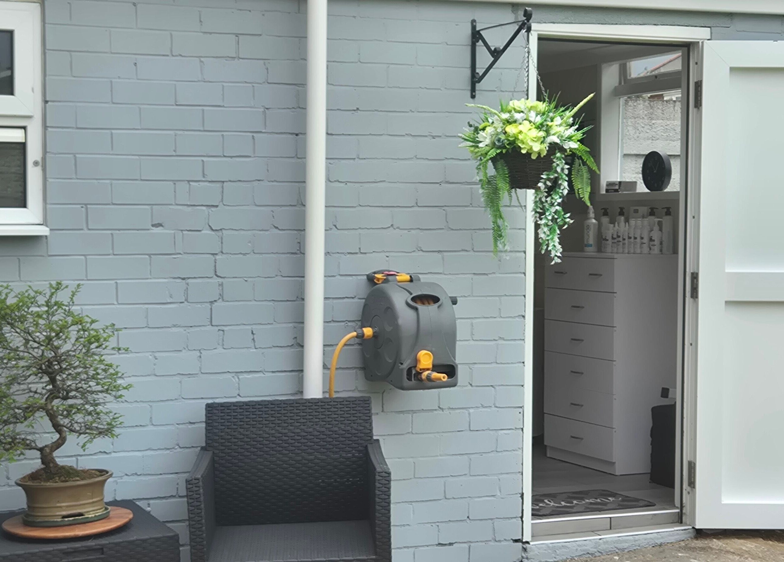 Charming entrance at Fingers and Toes, Mexborough, England, GB, featuring seating, a potted plant, and flowers.