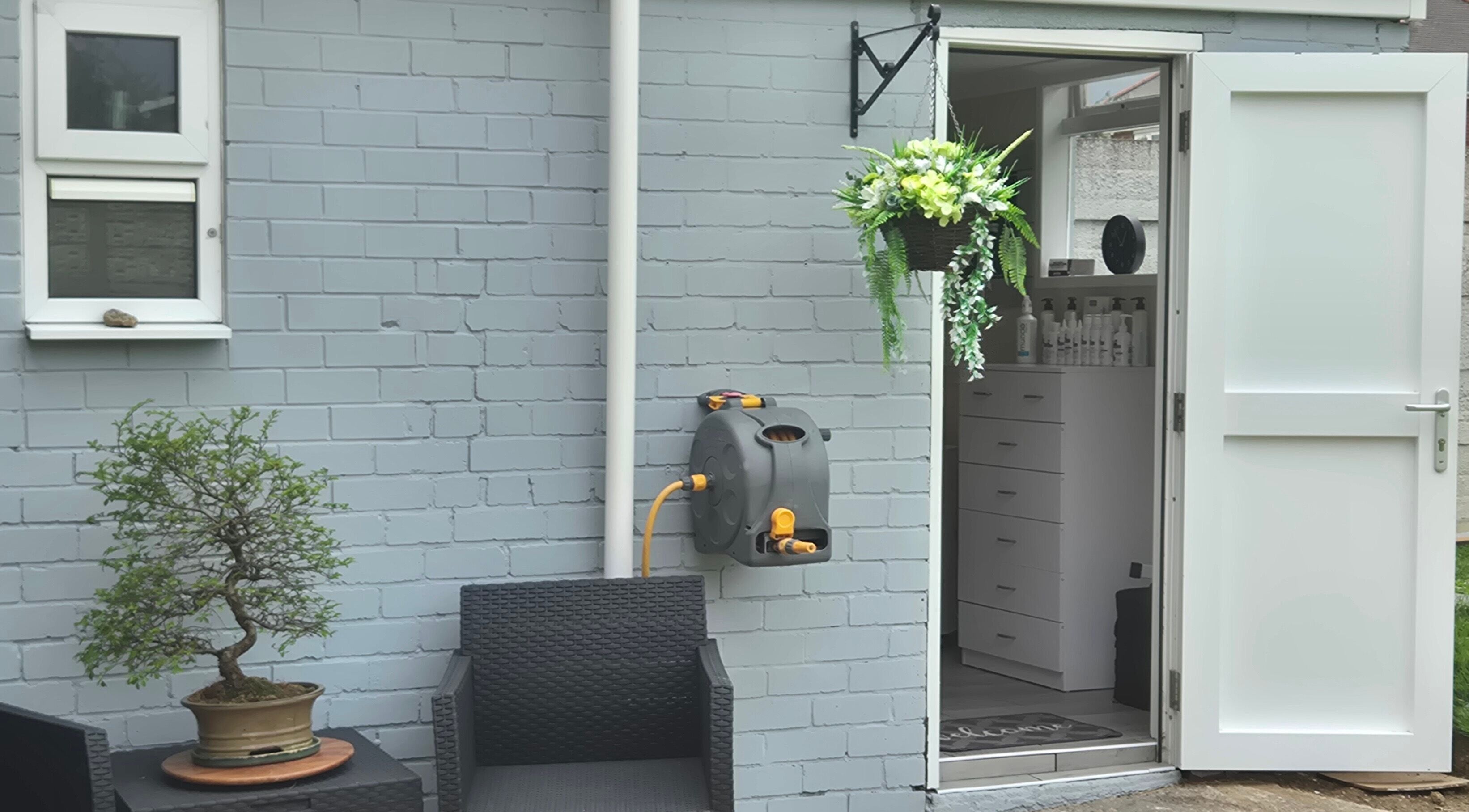 Charming entrance at Fingers and Toes, Mexborough, England, GB, featuring seating, a potted plant, and flowers.