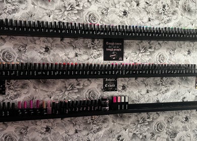 Nail polish display at Nails by Emma, Driffield, England, GB against floral wall.