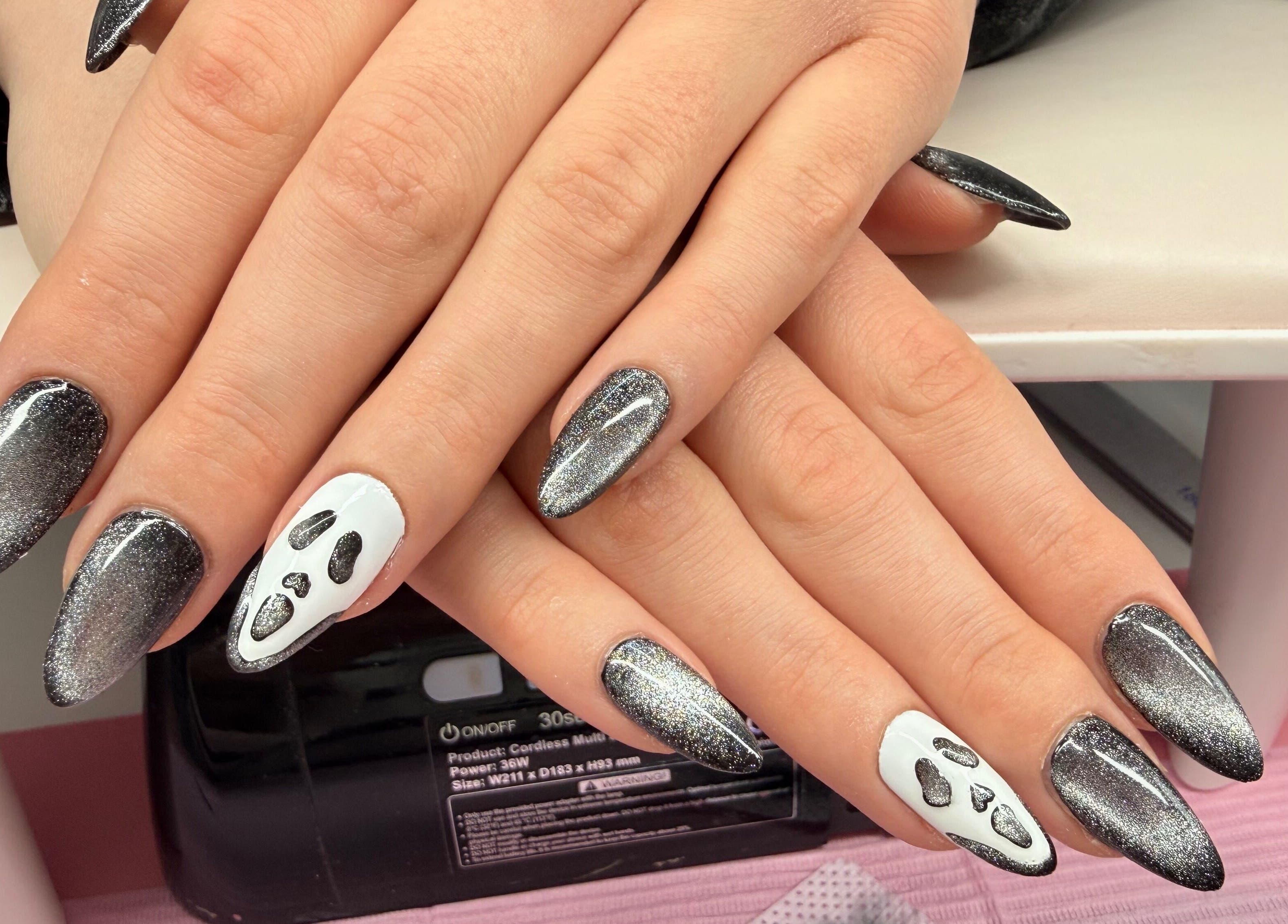 Nail art with black shimmer and ghost design at Nails by Emma, Norton, England, GB.