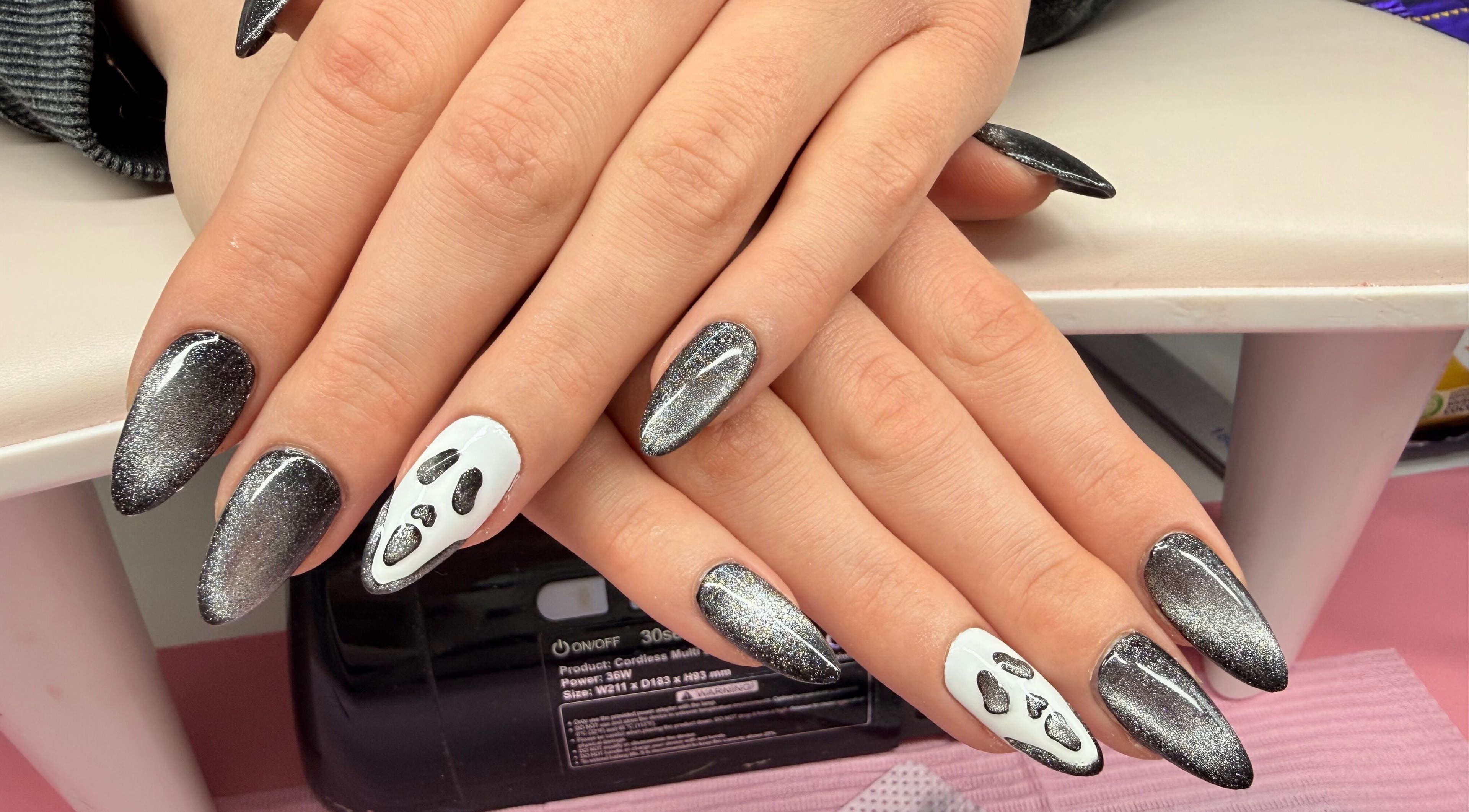 Nail art with black shimmer and ghost design at Nails by Emma, Norton, England, GB.