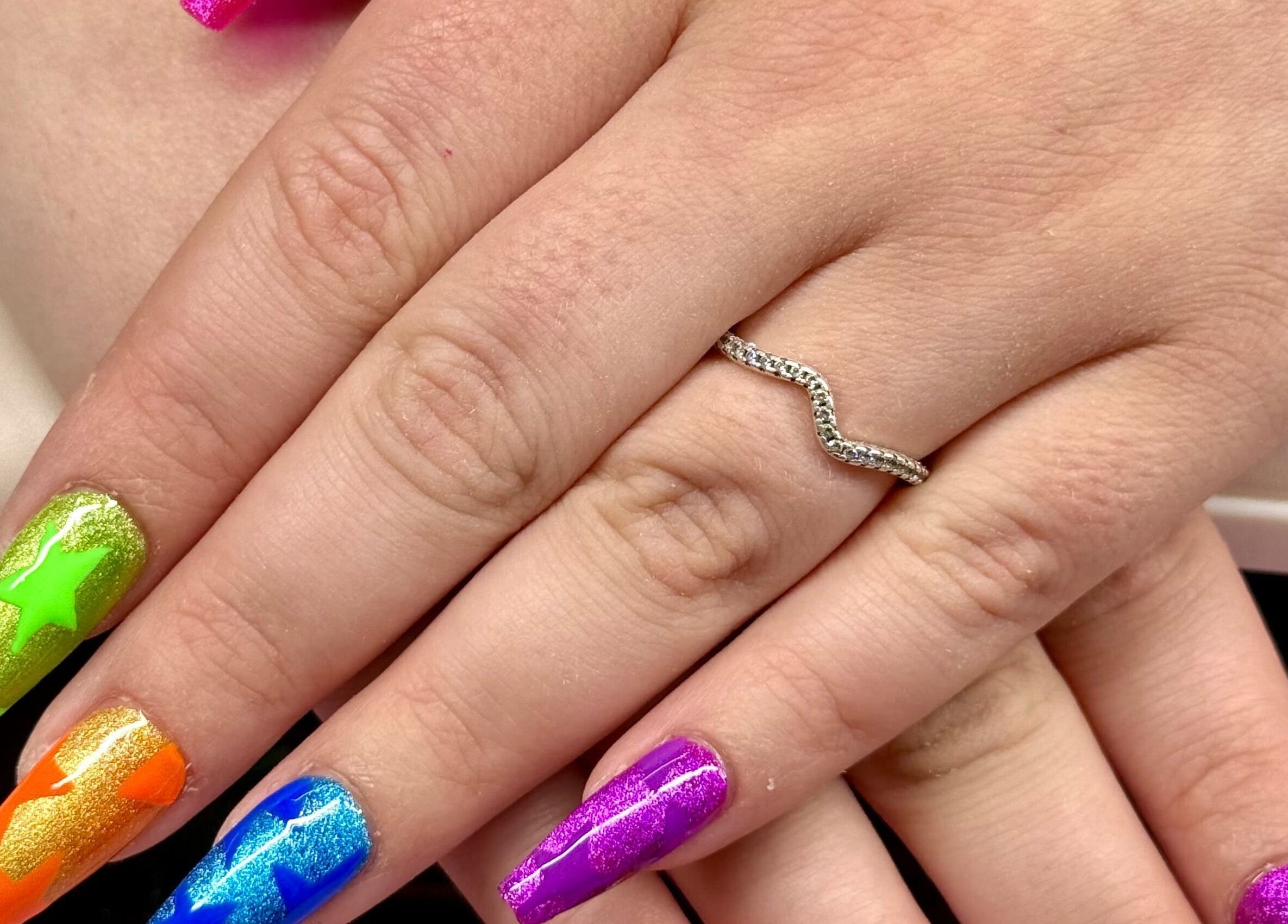 Colorful star-themed nail art by Nails by Emma in Norton, England, GB, showcasing vibrant creativity.