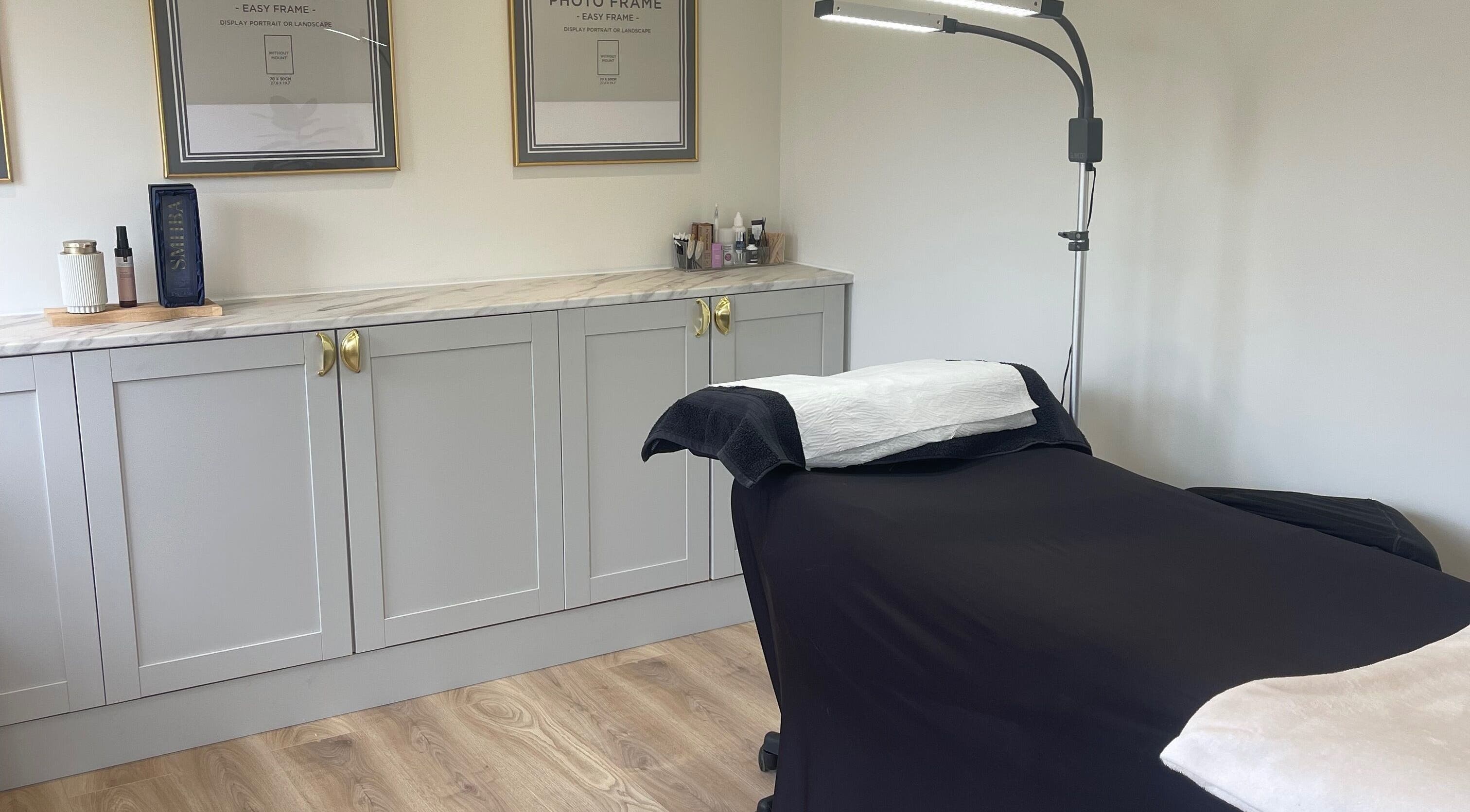 Tranquil treatment room at No. 1 Beauty, Whitfield, England, GB, featuring a massage bed and elegant decor.