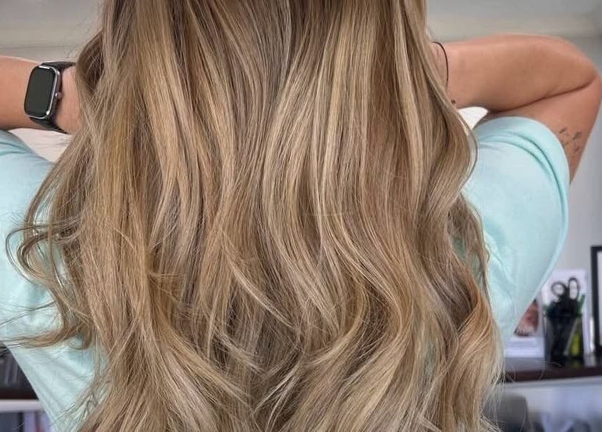 Flowing blonde hair styled with finesse at Fidelis Creations, Mabank, Texas, US.