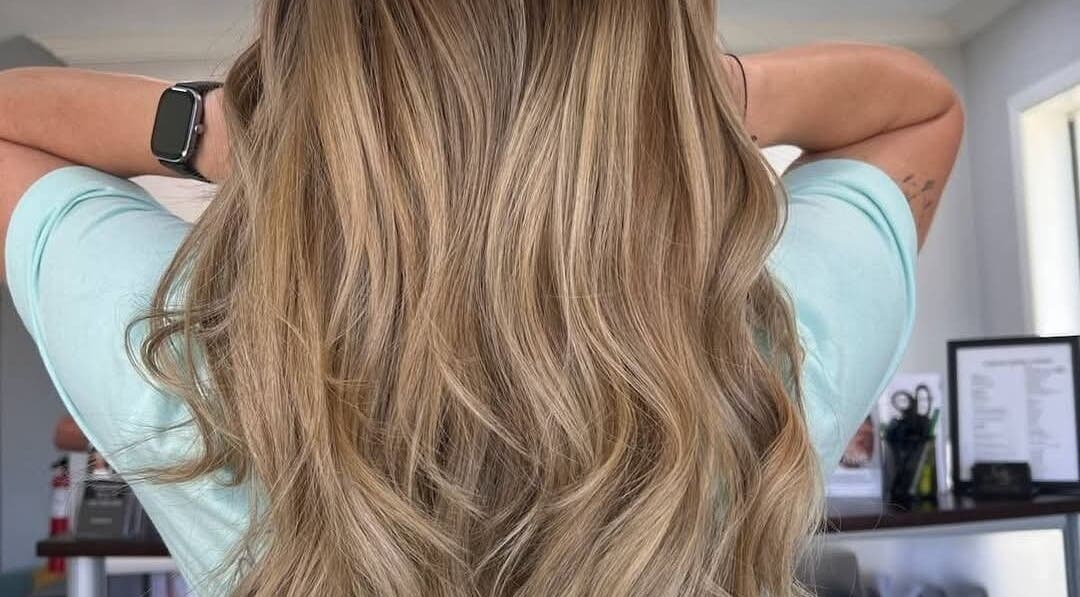 Flowing blonde hair styled with finesse at Fidelis Creations, Mabank, Texas, US.