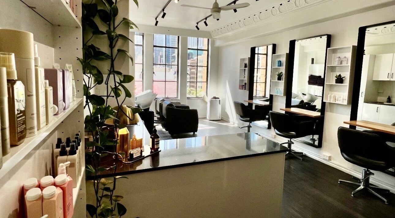 Stylish and modern interior of Bradley Rose Hair in Melbourne, Victoria, AU, featuring mirrors and seating.