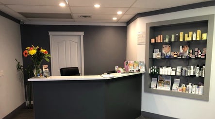 Reception area of ERA Massage & Beauty with product display in Calgary, Alberta, CA.