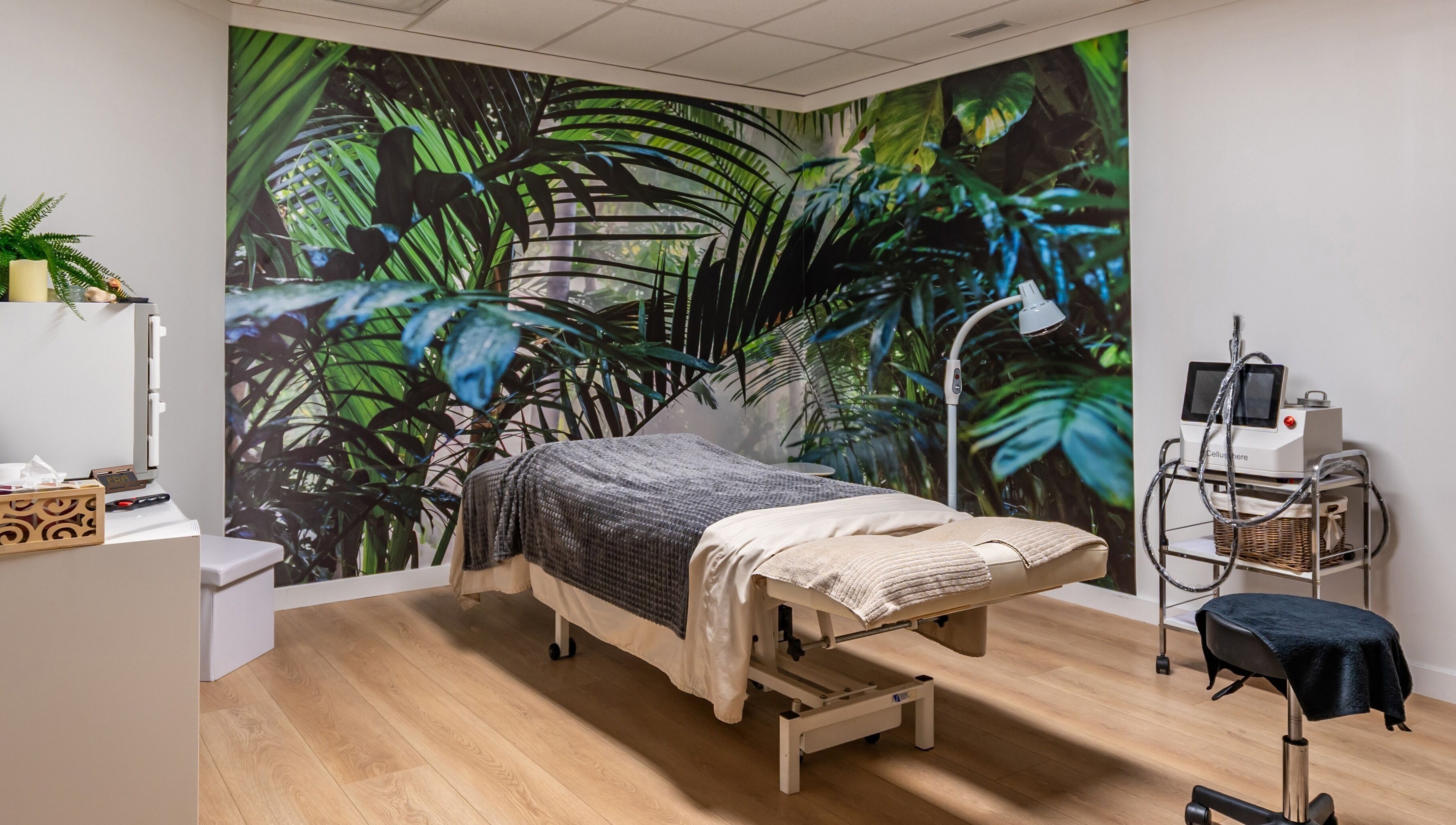 Tranquil massage room with tropical mural at ERA Massage & Beauty in Calgary, Alberta, CA.