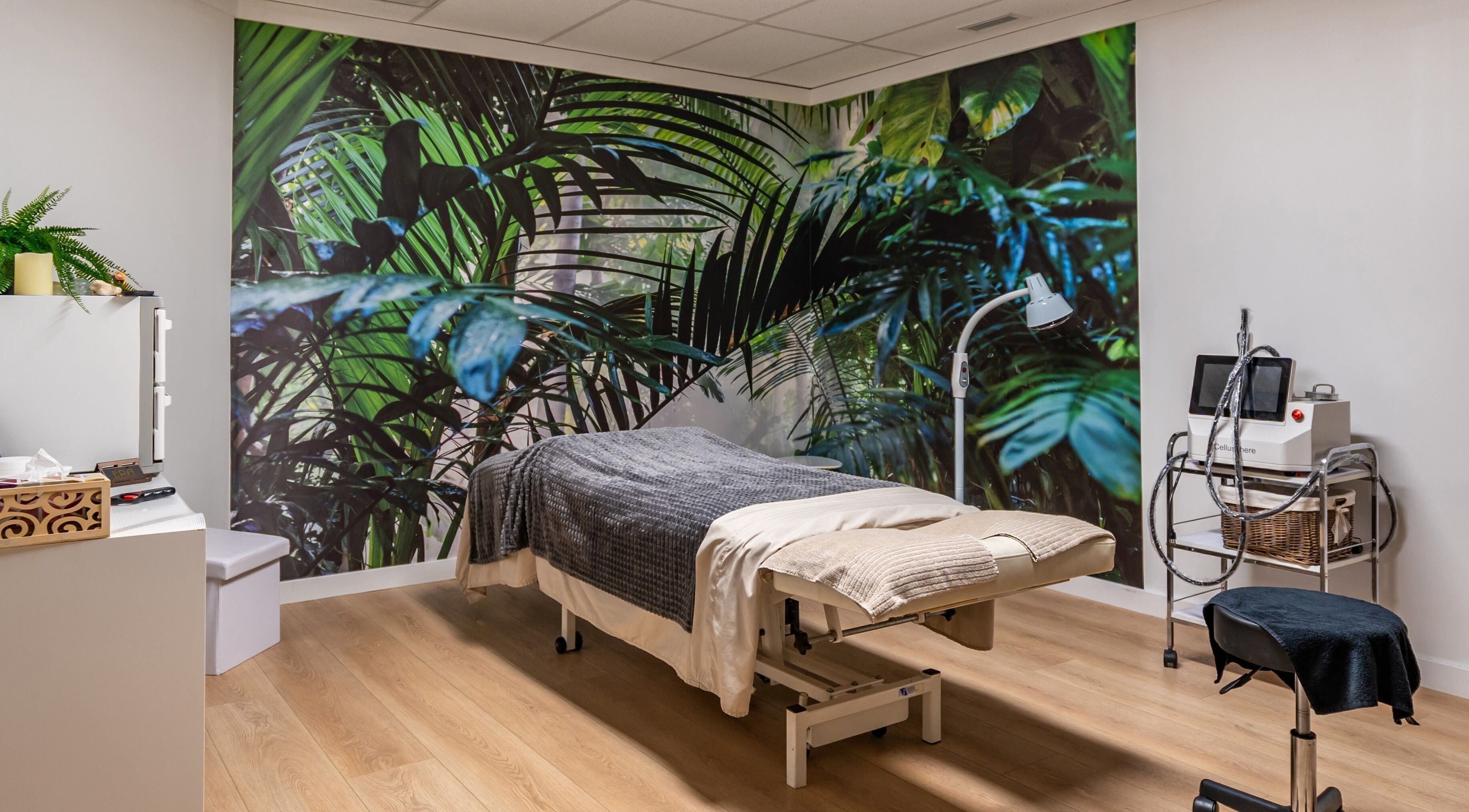 Tranquil massage room with tropical mural at ERA Massage & Beauty in Calgary, Alberta, CA.