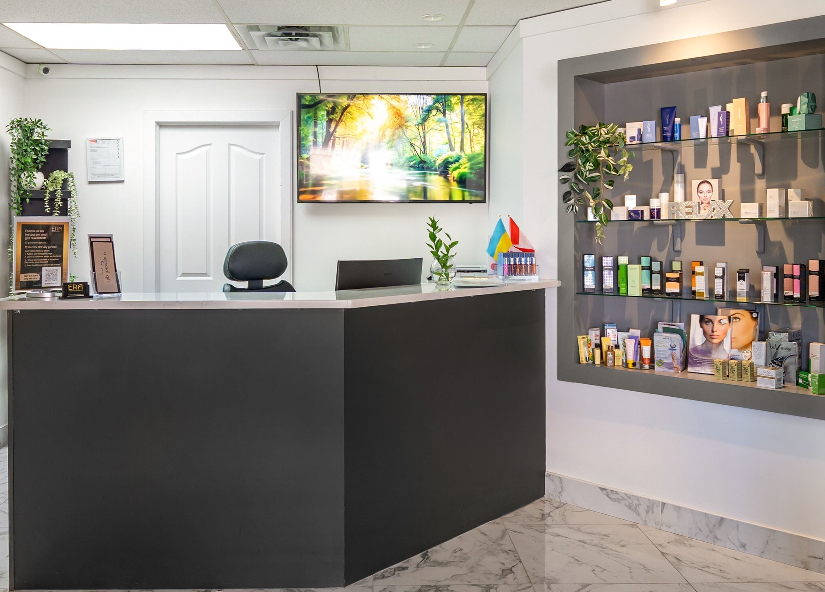 Reception area of ERA Massage & Beauty in Calgary, Alberta, CA, featuring elegant decor and product display.