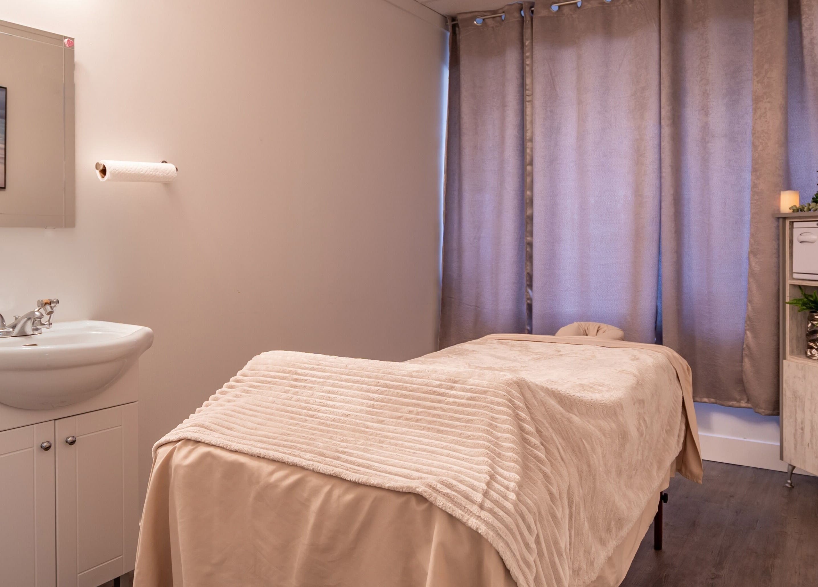 Cozy massage room at ERA Massage & Beauty in Calgary, Alberta, CA with a welcoming ambiance and plush furnishings.