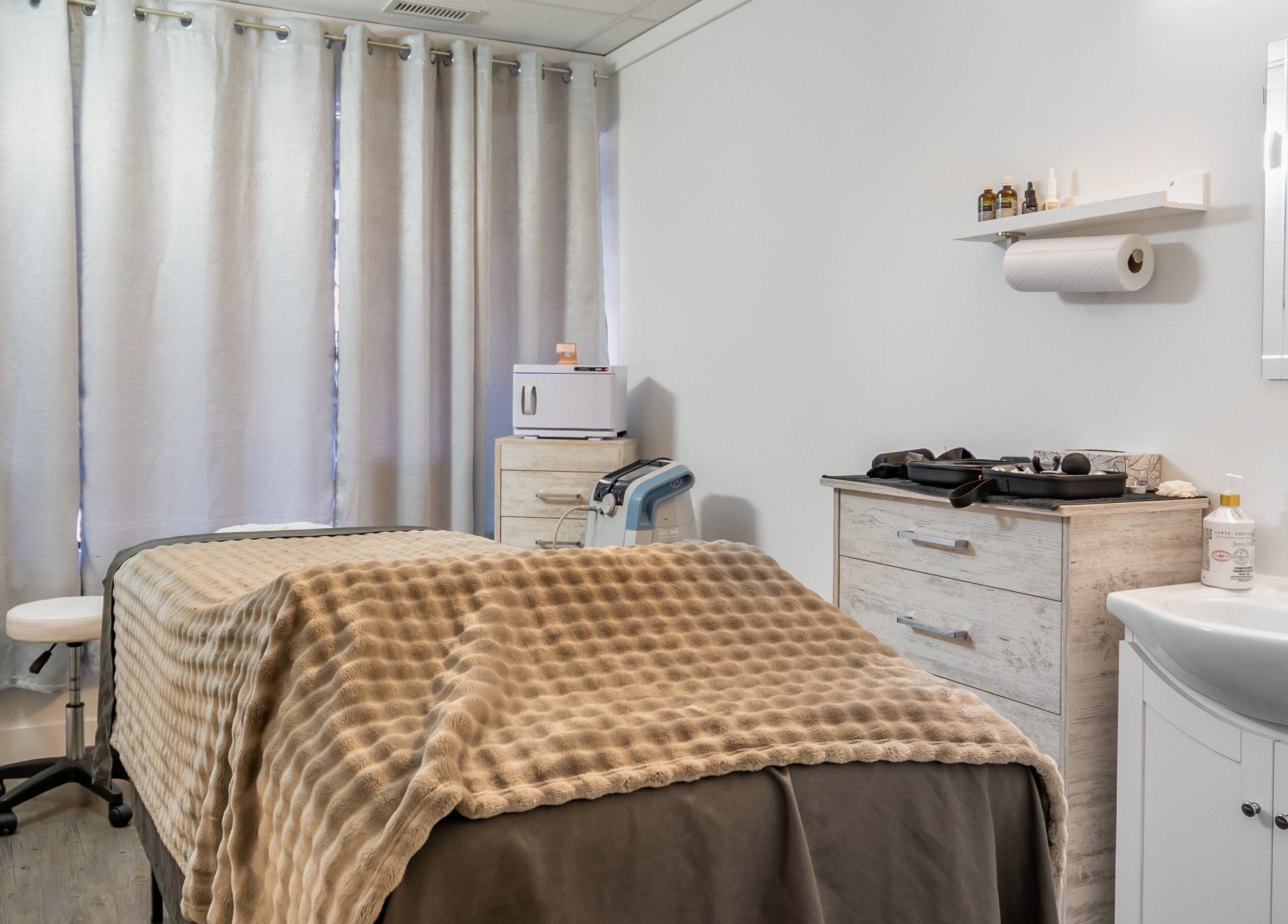 Calming massage room at ERA Massage & Beauty, Calgary, Alberta, CA with cozy decor and soft lighting.