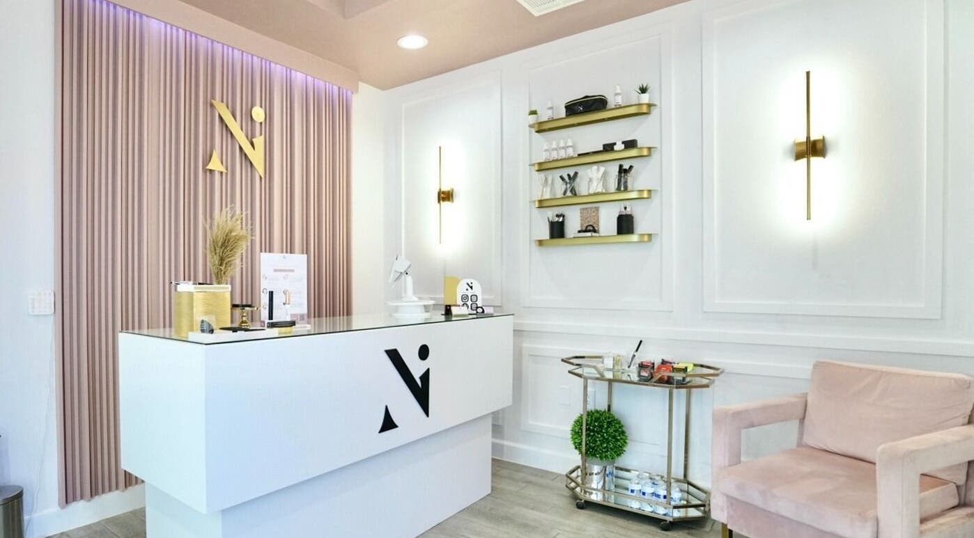 Reception area of Nadia Isabel Studio in Katy, Texas, US, featuring modern decor and plush seating.