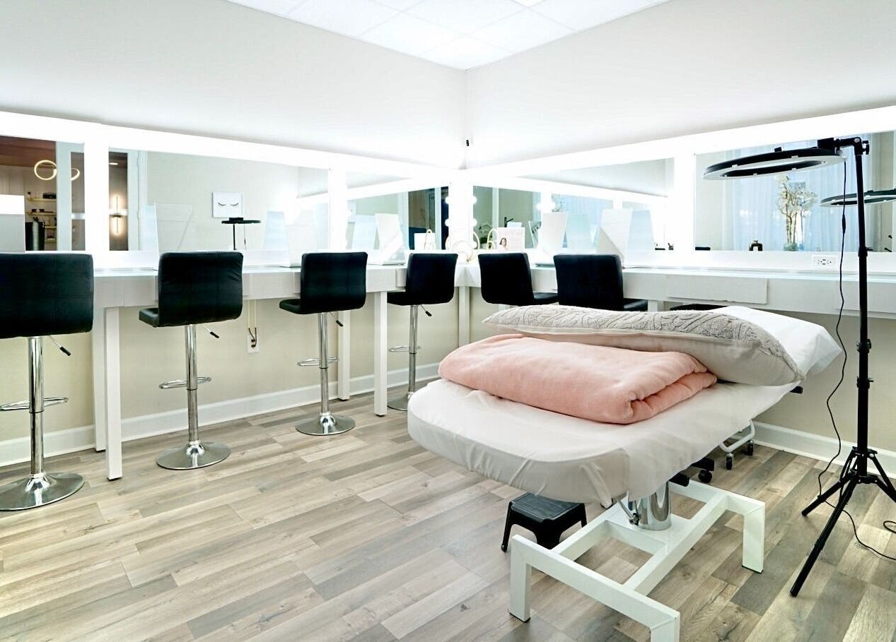 Modern beauty studio interior at Nadia Isabel Studio, Katy, Texas, US showcasing stylish chairs and a treatment bed.