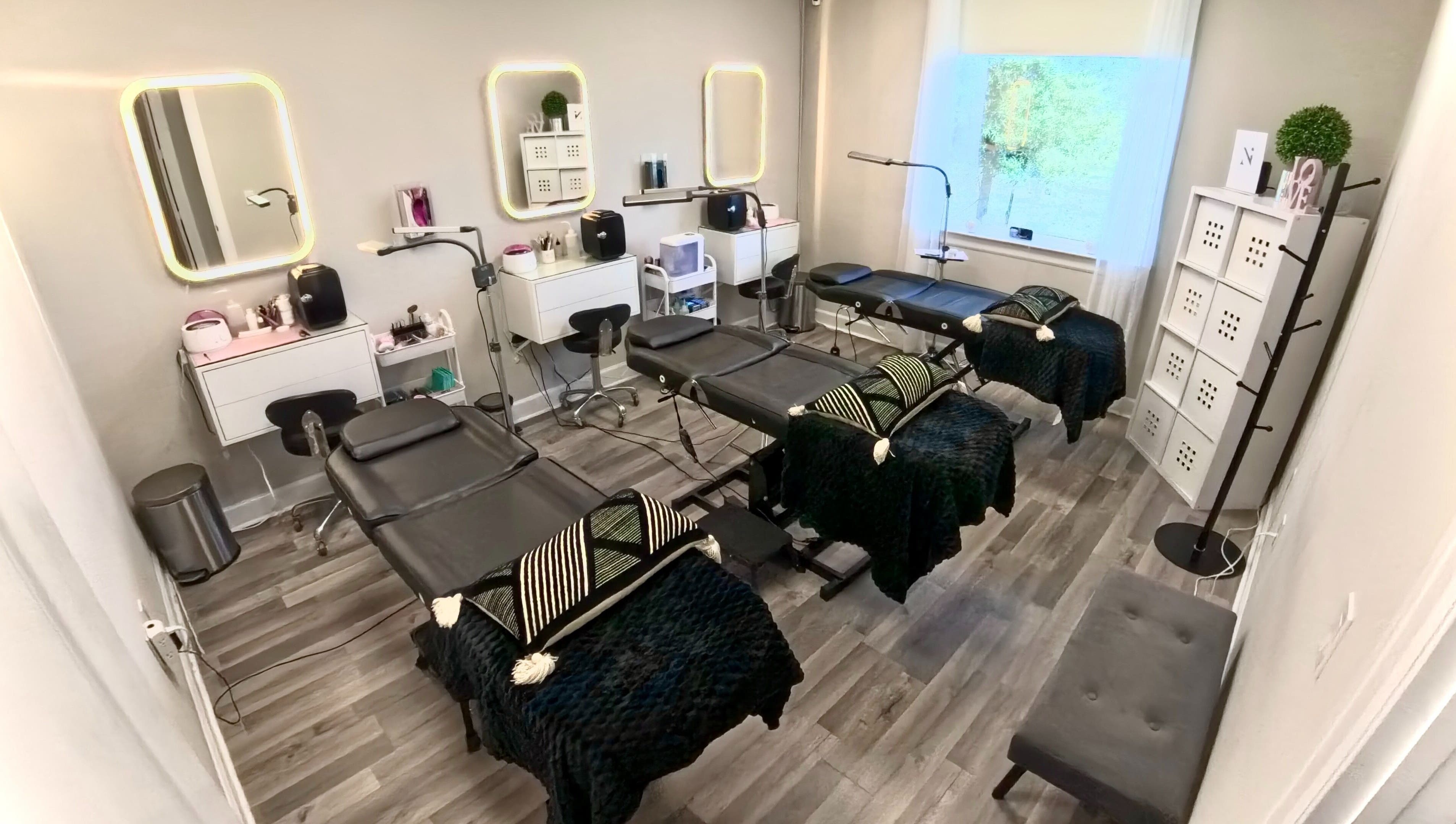 Sophisticated interior of Nadia Isabel Studio in Katy, Texas, US, featuring elegant treatment beds and beauty stations.