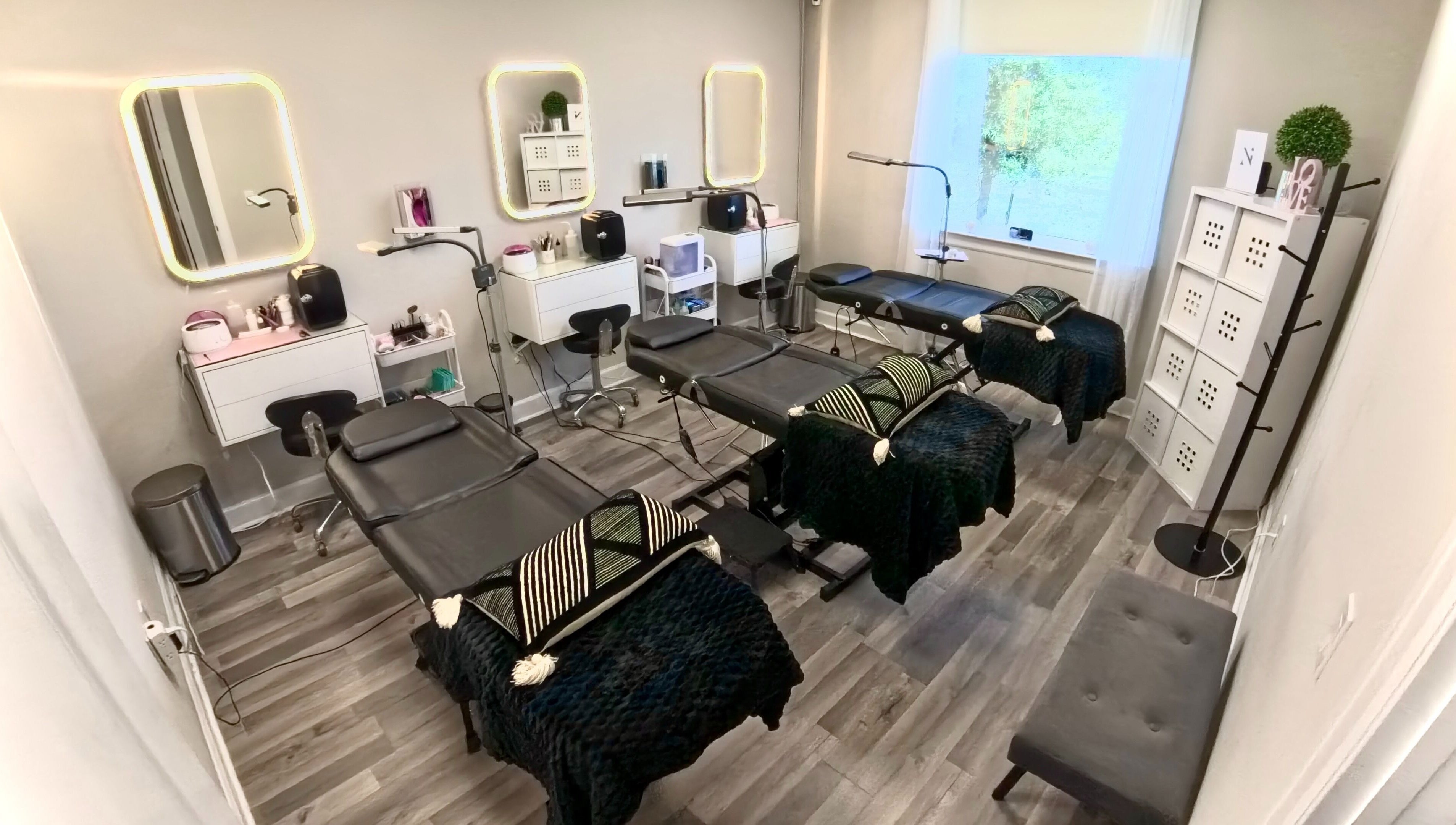 Sophisticated interior of Nadia Isabel Studio in Katy, Texas, US, featuring elegant treatment beds and beauty stations.
