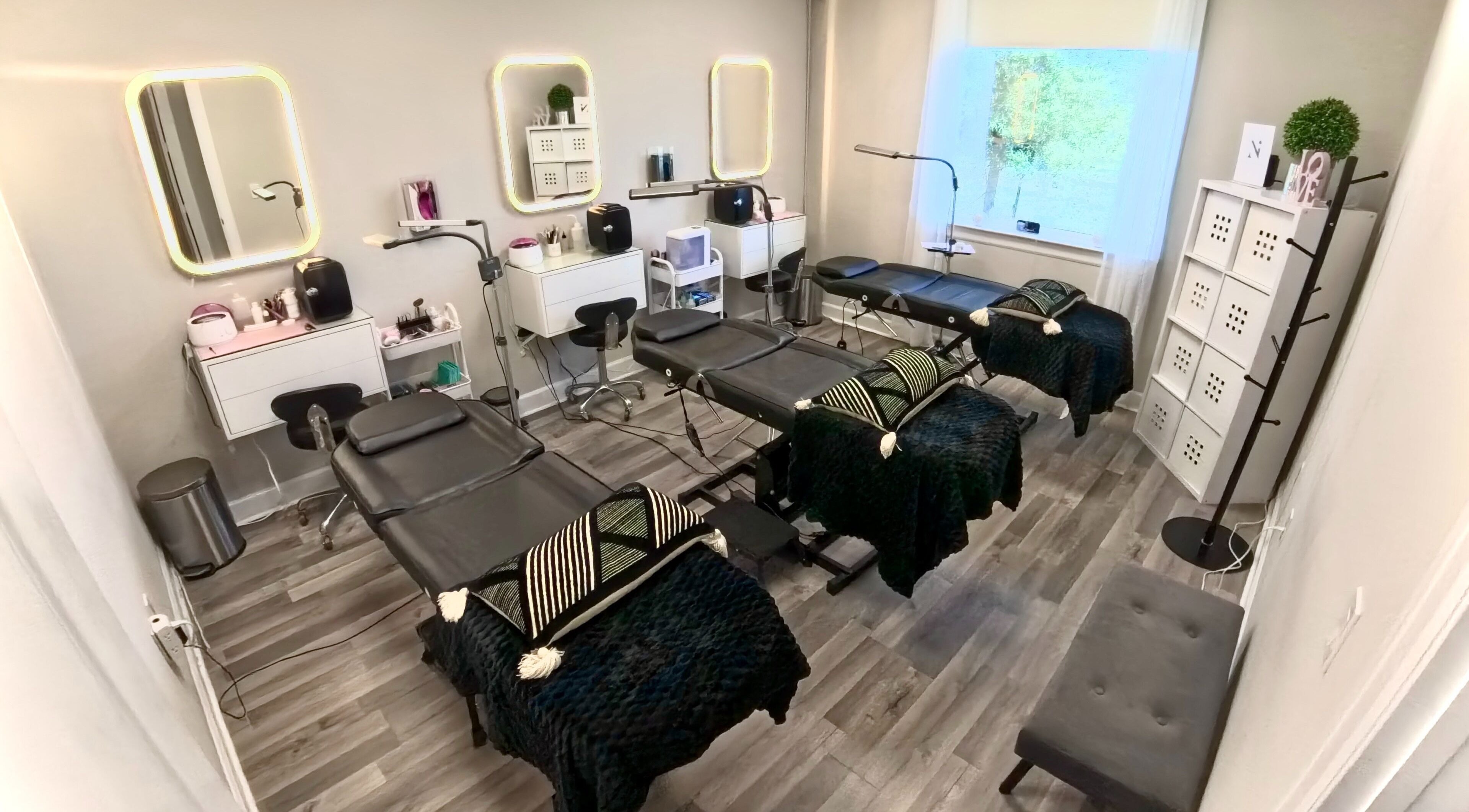Elegant treatment room at Nadia Isabel Studio, Katy, Texas, US with plush beds and modern decor.
