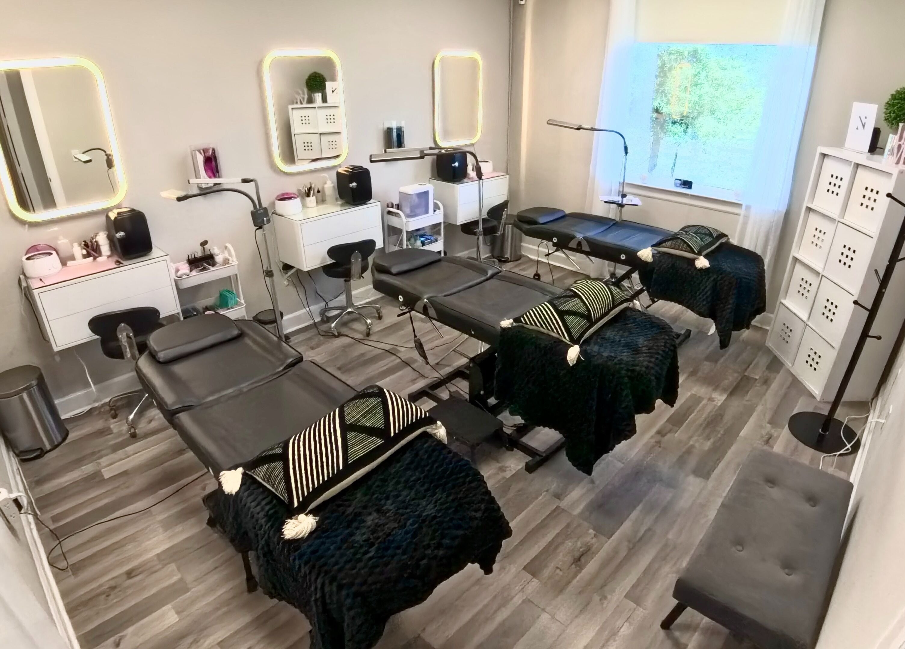 Inside Nadia Isabel Studio, Katy, Texas: modern treatment beds, mirrors, and serene decor for beauty and wellness.