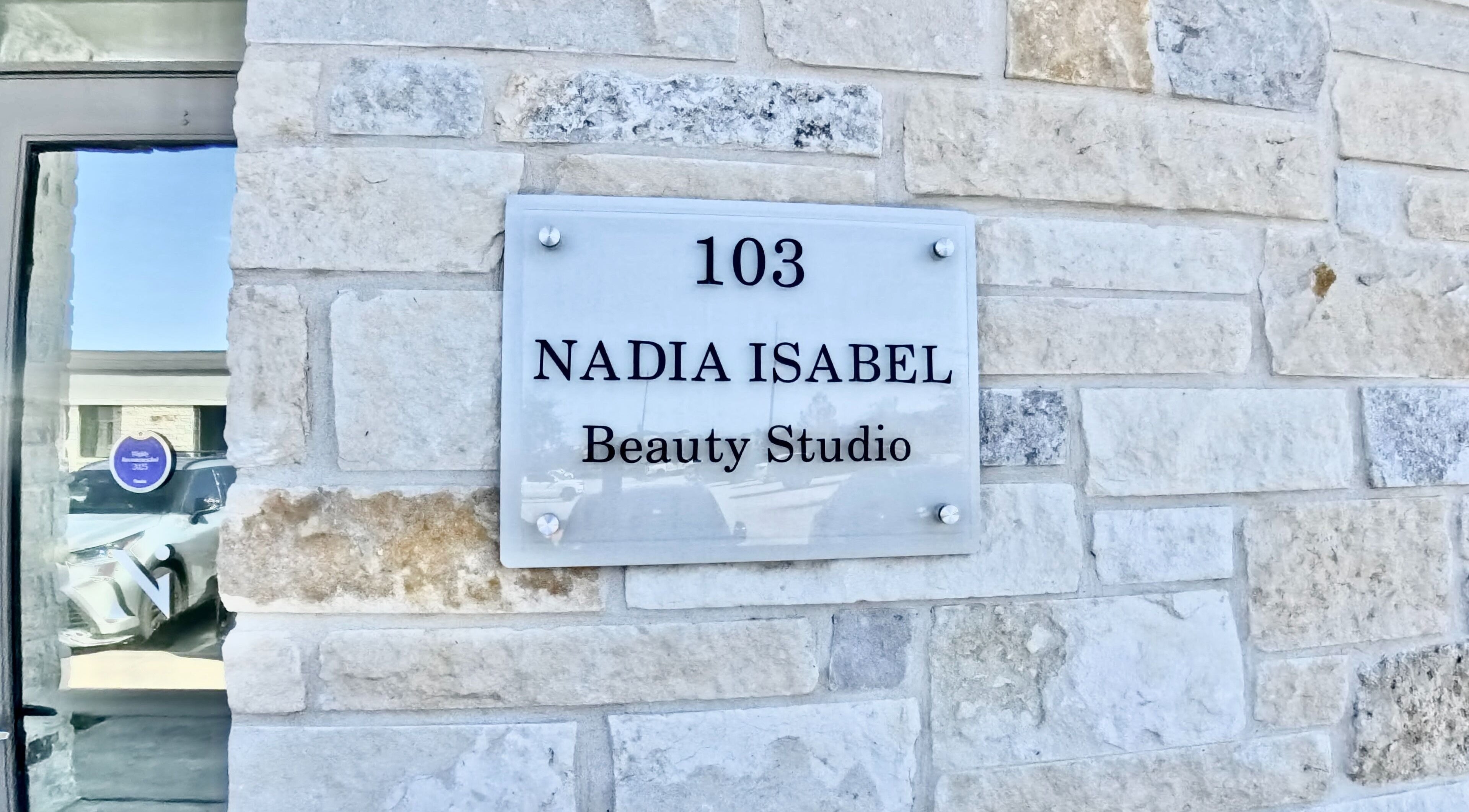 Nadia Isabel Studio entrance sign at 103, Katy, Texas, US, showcasing a stylish beauty studio.