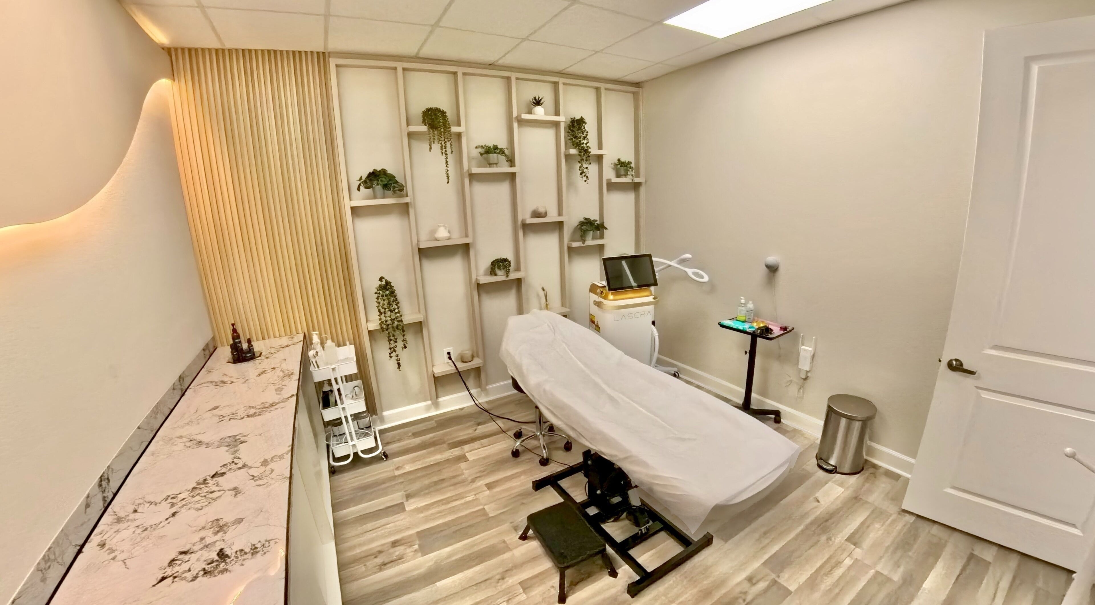 Nadia Isabel Studio in Katy, Texas, offers a serene treatment room with modern decor and spa amenities.