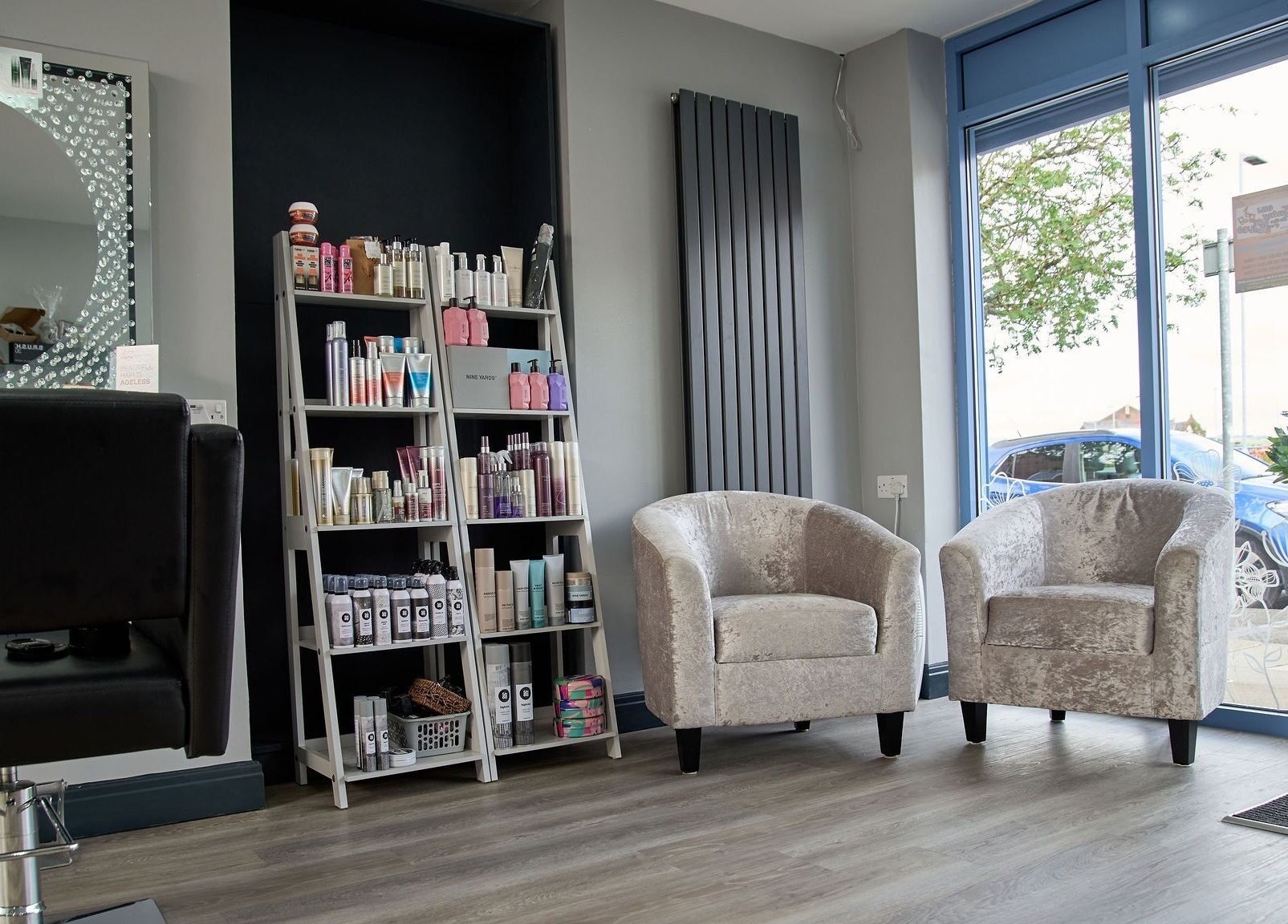 Stylish seating and product display at Liz Lewis Hair Studio, Chorley, England, GB.