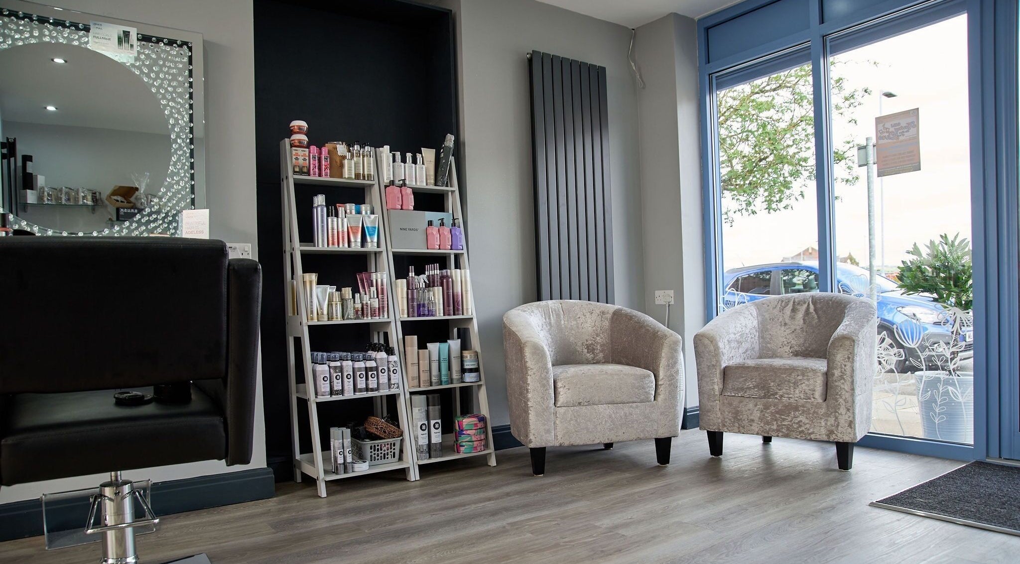 Stylish seating and product display at Liz Lewis Hair Studio, Chorley, England, GB.