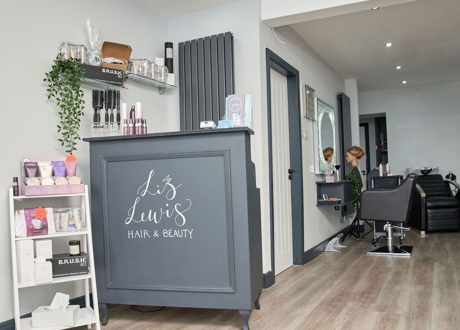 Elegant interior of Liz Lewis Hair Studio in Chorley, England, GB, featuring salon products and styling chairs.