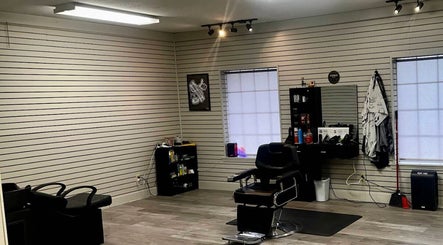 Spacious interior of Cut-N-Up Barbershop in Arkadelphia, Arkansas, US, featuring a barber chair and equipment.