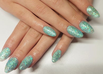 Glittery manicured nails at Cody's nail boutique, Portsmouth, England, GB, showcasing chic nail art.