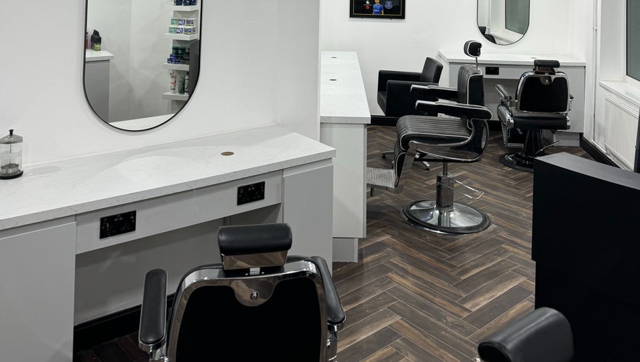 Modern interior of Chax Barbers Heathcote Road, Stoke-on-Trent, England, GB, featuring stylish chairs and mirrors.