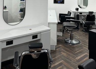 Modern interior of Chax Barbers Heathcote Road, Stoke-on-Trent, England, GB, featuring stylish chairs and mirrors.