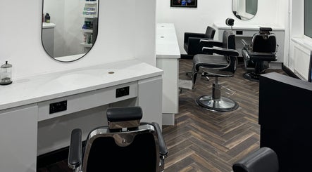 Modern interior of Chax Barbers Heathcote Road, Stoke-on-Trent, England, GB, featuring stylish chairs and mirrors.