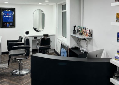 Interior of Chax Barbers Heathcote Road in Stoke-on-Trent, England, GB with modern chairs and grooming products.