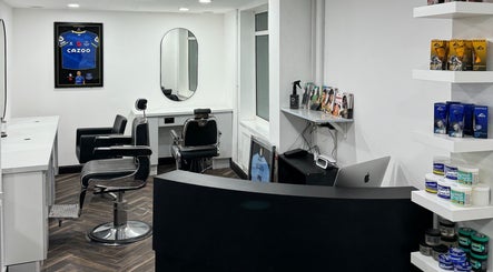 Interior of Chax Barbers Heathcote Road in Stoke-on-Trent, England, GB with modern chairs and grooming products.