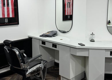 Modern barber chair at Chax Barbers Heathcote Road, Stoke-on-Trent, England, GB near sleek counter.