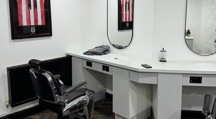 Modern barber chair at Chax Barbers Heathcote Road, Stoke-on-Trent, England, GB near sleek counter.
