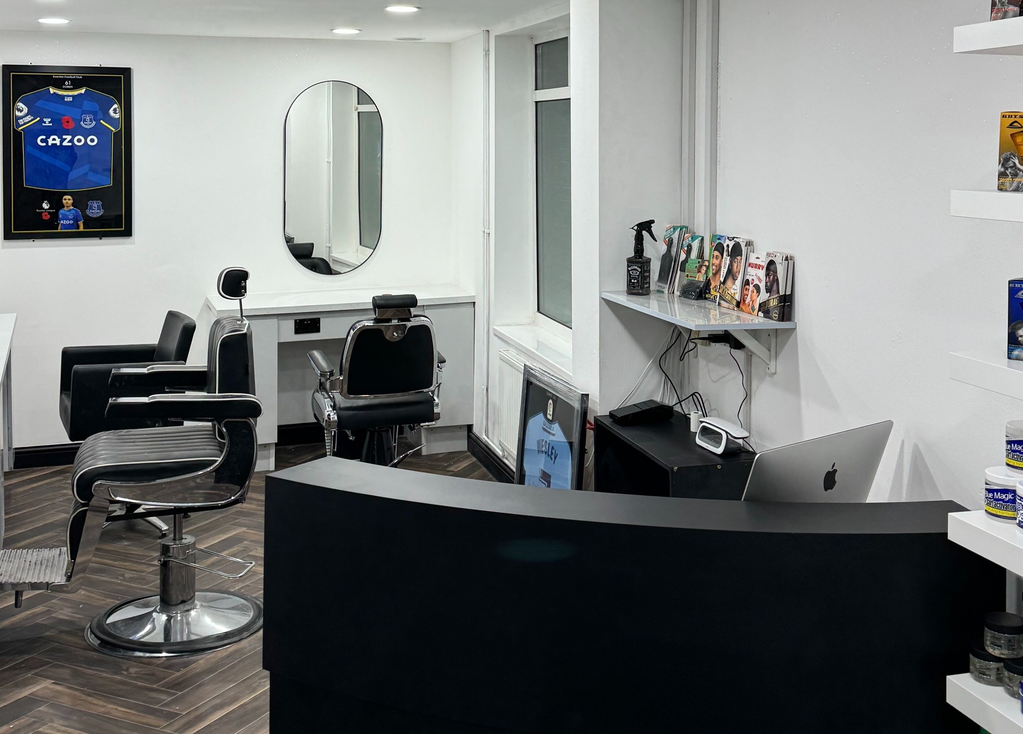 Modern interior of Chax Barbers Heathcote Road, Stoke-on-Trent, England, GB with sleek barber chairs and products.