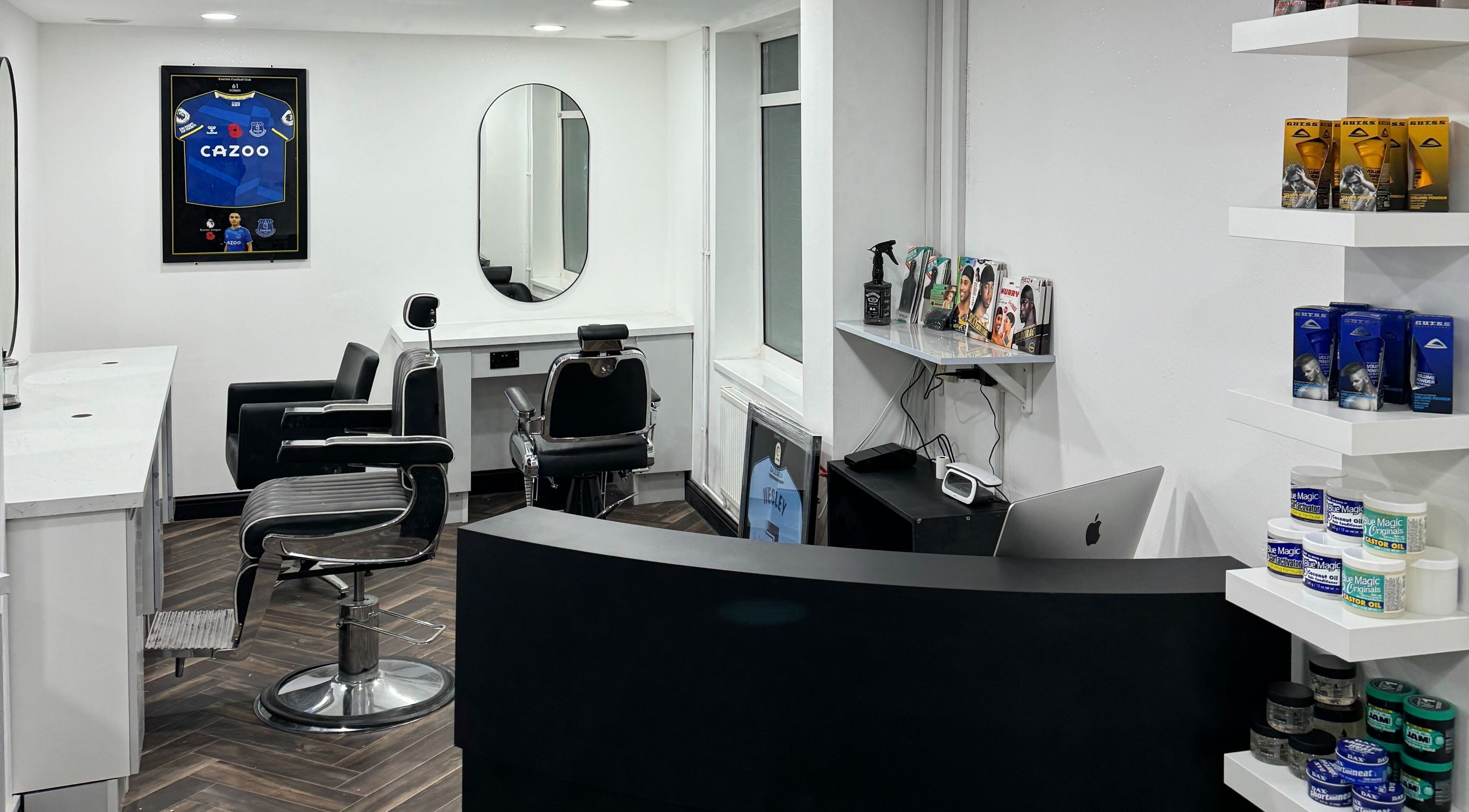 Modern interior of Chax Barbers Heathcote Road, Stoke-on-Trent, England, GB with sleek barber chairs and products.