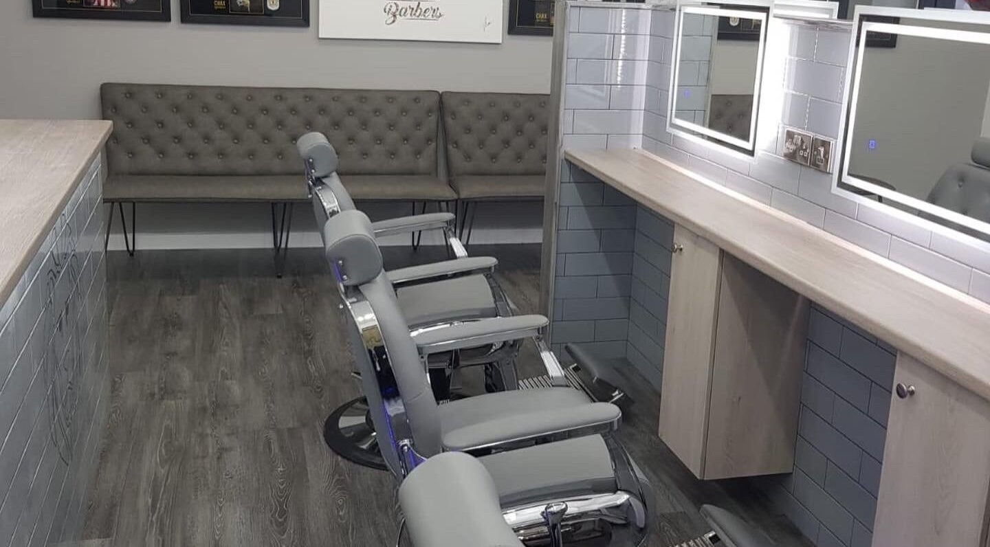 Chax Barbers | Queen Street features sleek chairs in Stoke-on-Trent, England, GB's modern grooming space.