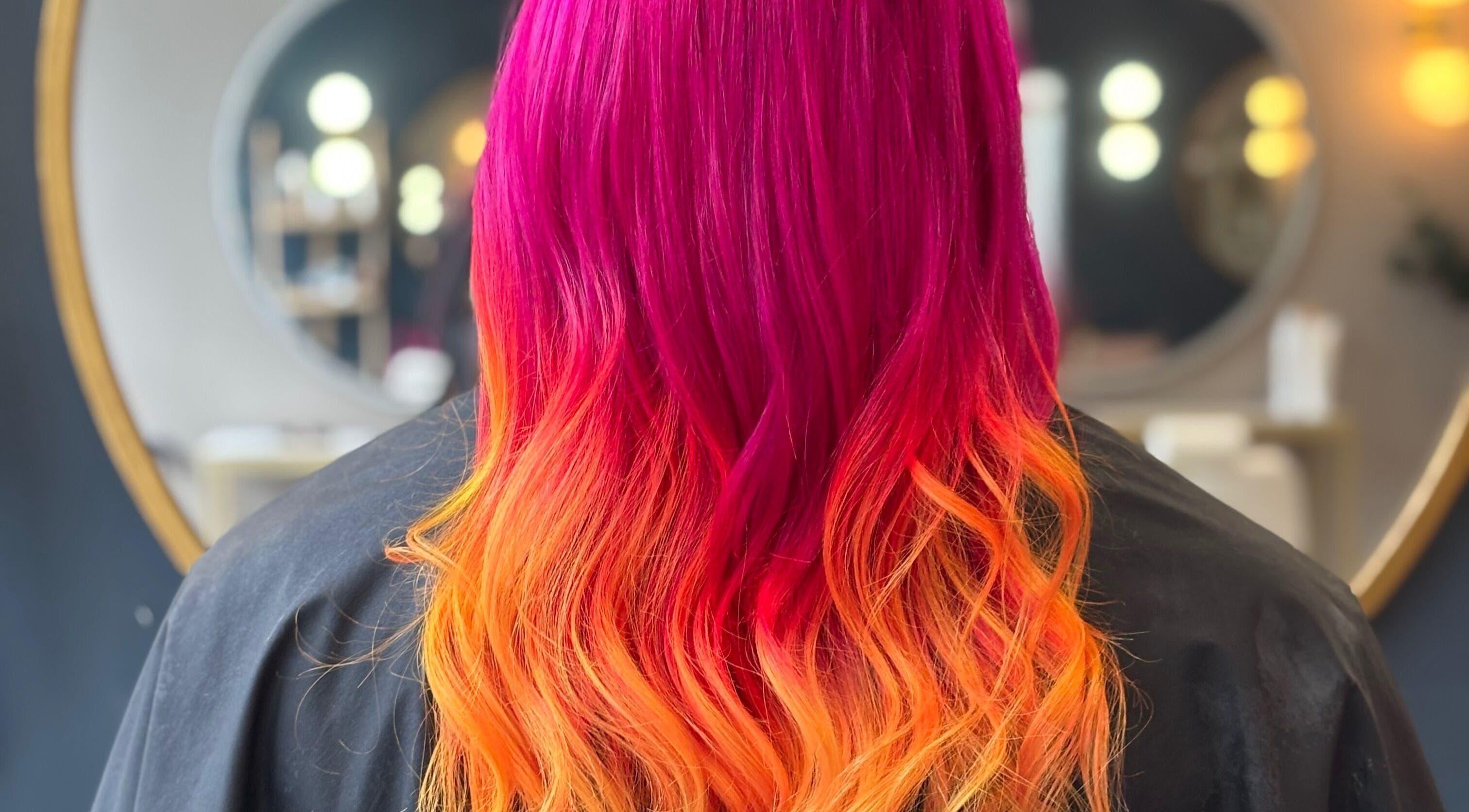 Vibrant pink to orange ombre hair at Mel Bowman Hairdressing, Harrogate, England, GB.