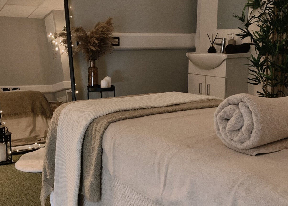 Serene massage room at HB Holistic Massage, Belfast, Northern Ireland, GB, featuring cozy decor and soft lighting.