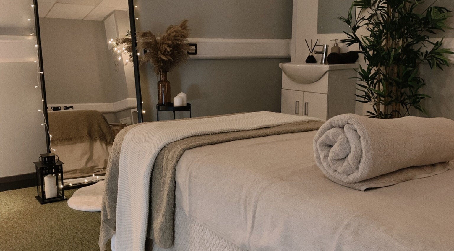 Serene massage room at HB Holistic Massage, Belfast, Northern Ireland, GB, featuring cozy decor and soft lighting.