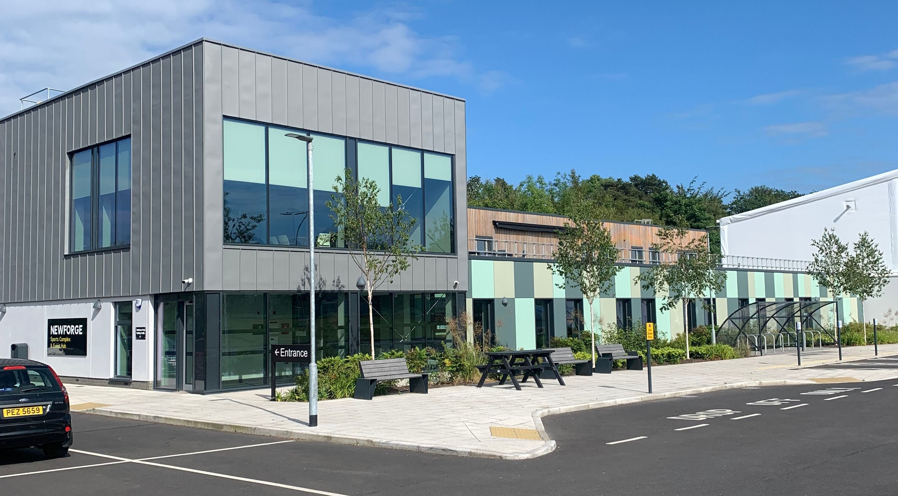 Front view of HB Holistic Massage at Newforge complex, Belfast, Northern Ireland, GB, featuring modern architecture.
