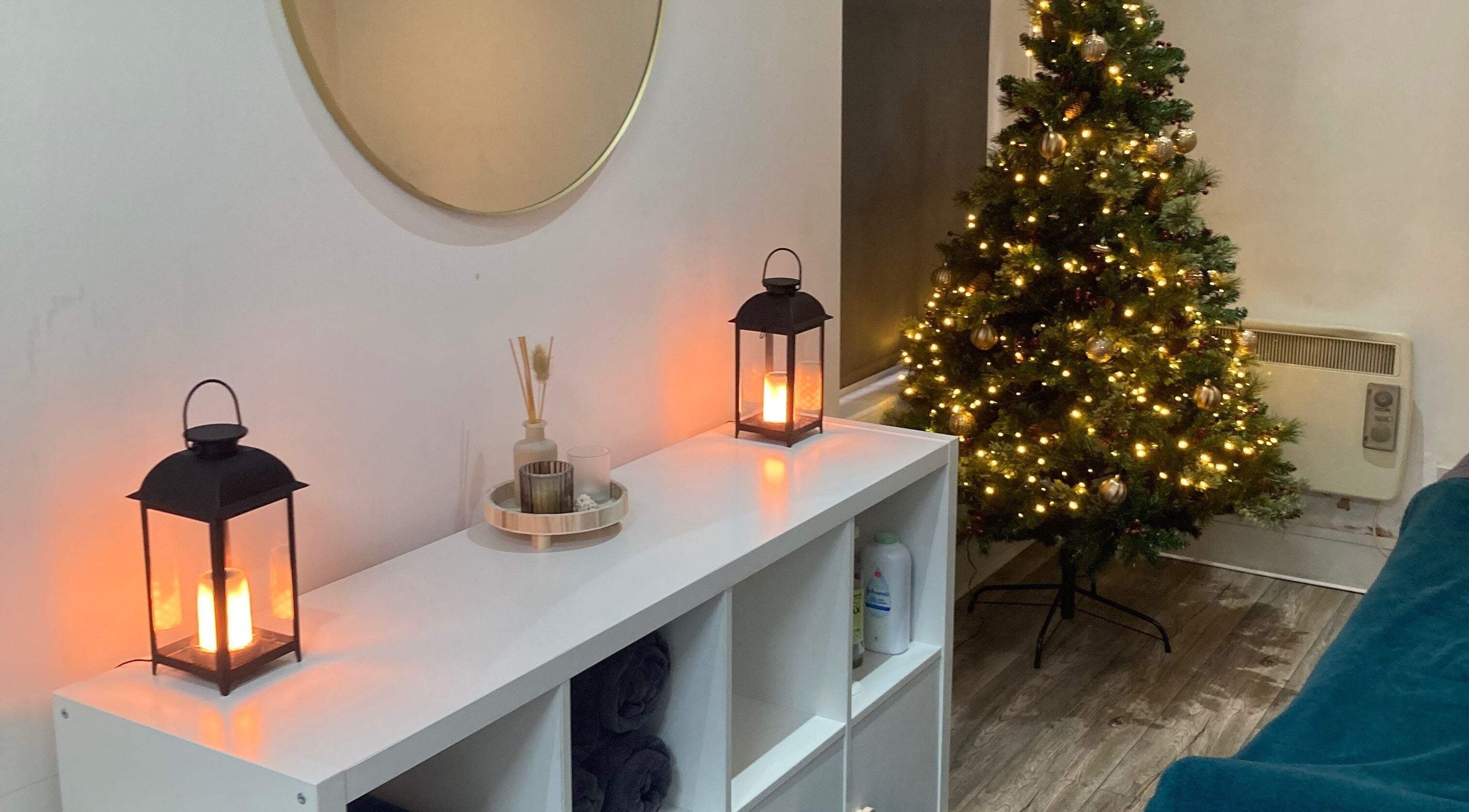 Cozy festive corner at Nirvana Massage Therapy (New Location!), Aberdeen, Scotland, GB with a glowing tree.