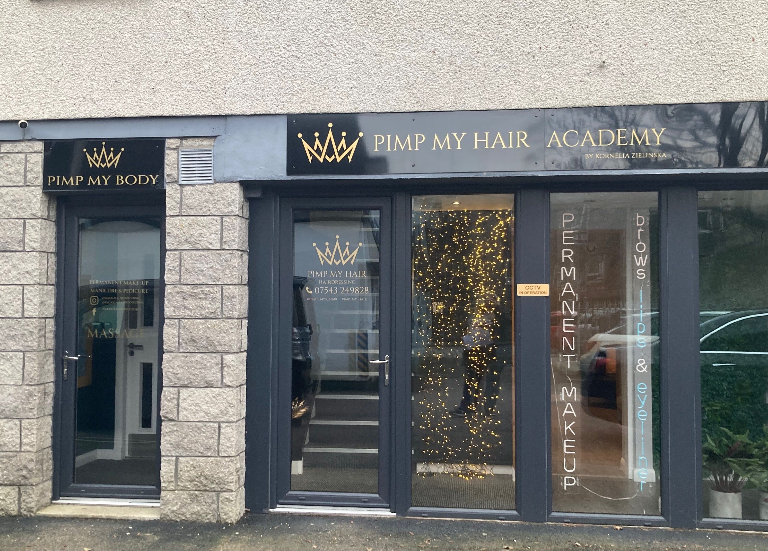 Front entrance of Nirvana Massage Therapy in Aberdeen, Scotland, GB, with stone walls and signage.