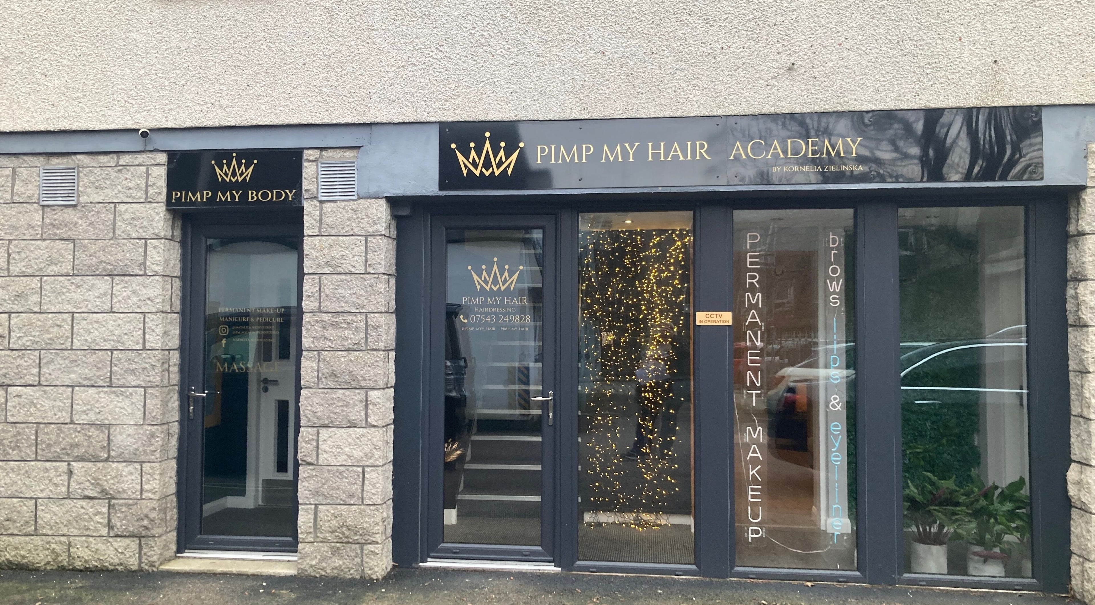 Front entrance of Nirvana Massage Therapy in Aberdeen, Scotland, GB, with stone walls and signage.