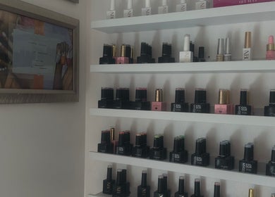 Nail polish on display at GLOW By Mads, Abbots Langley, England, GB, showcasing vibrant colors and brands.