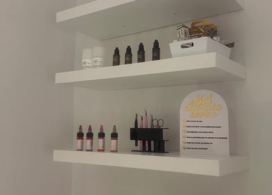 Organized beauty supplies on shelves at GLOW By Mads, Abbots Langley, England, GB.