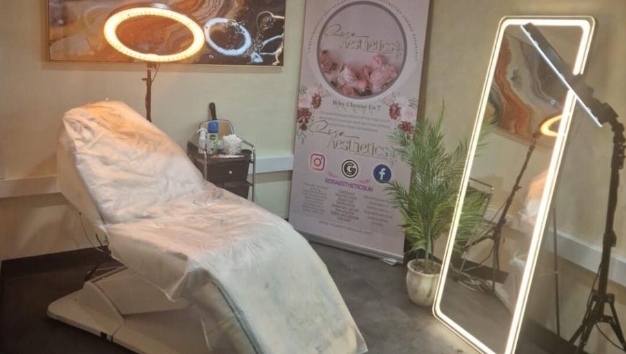 Cozy treatment room at Glow by Mads @ Rosa Aesthetics, Hemel Hempstead, England, GB with plush chair and ornate decor.